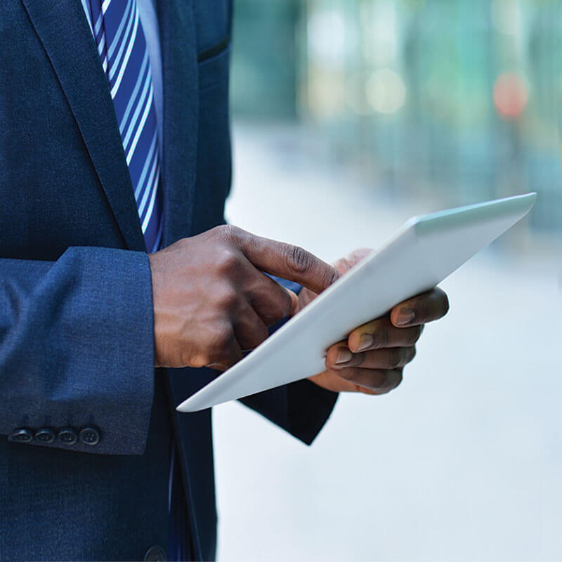 Man in suit using tablet